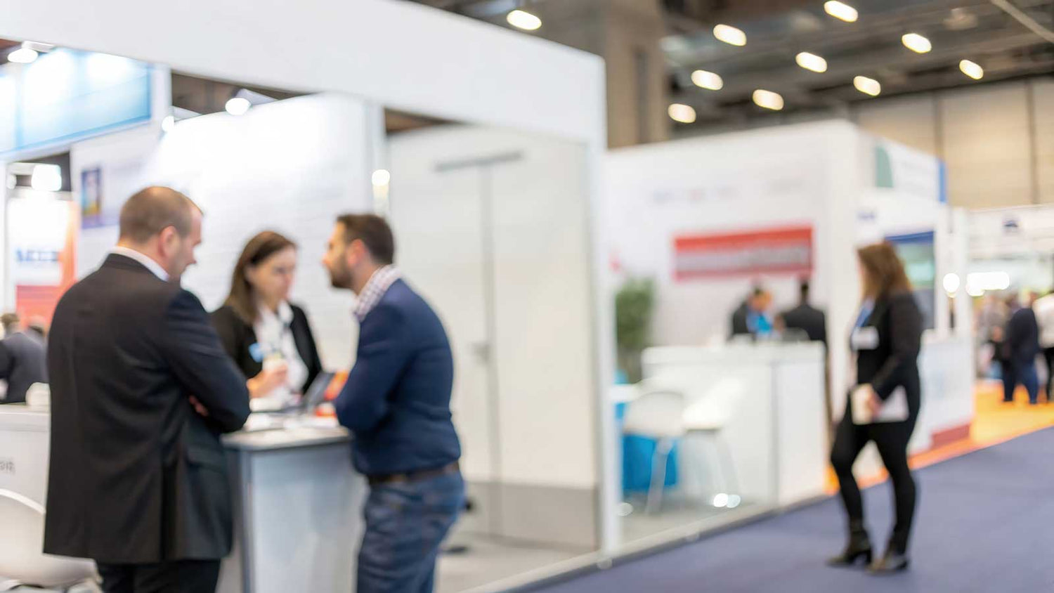 People talking at a trade show booth